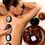 young-woman-getting-hot-stone-massage-in-spa-salon-.jpg